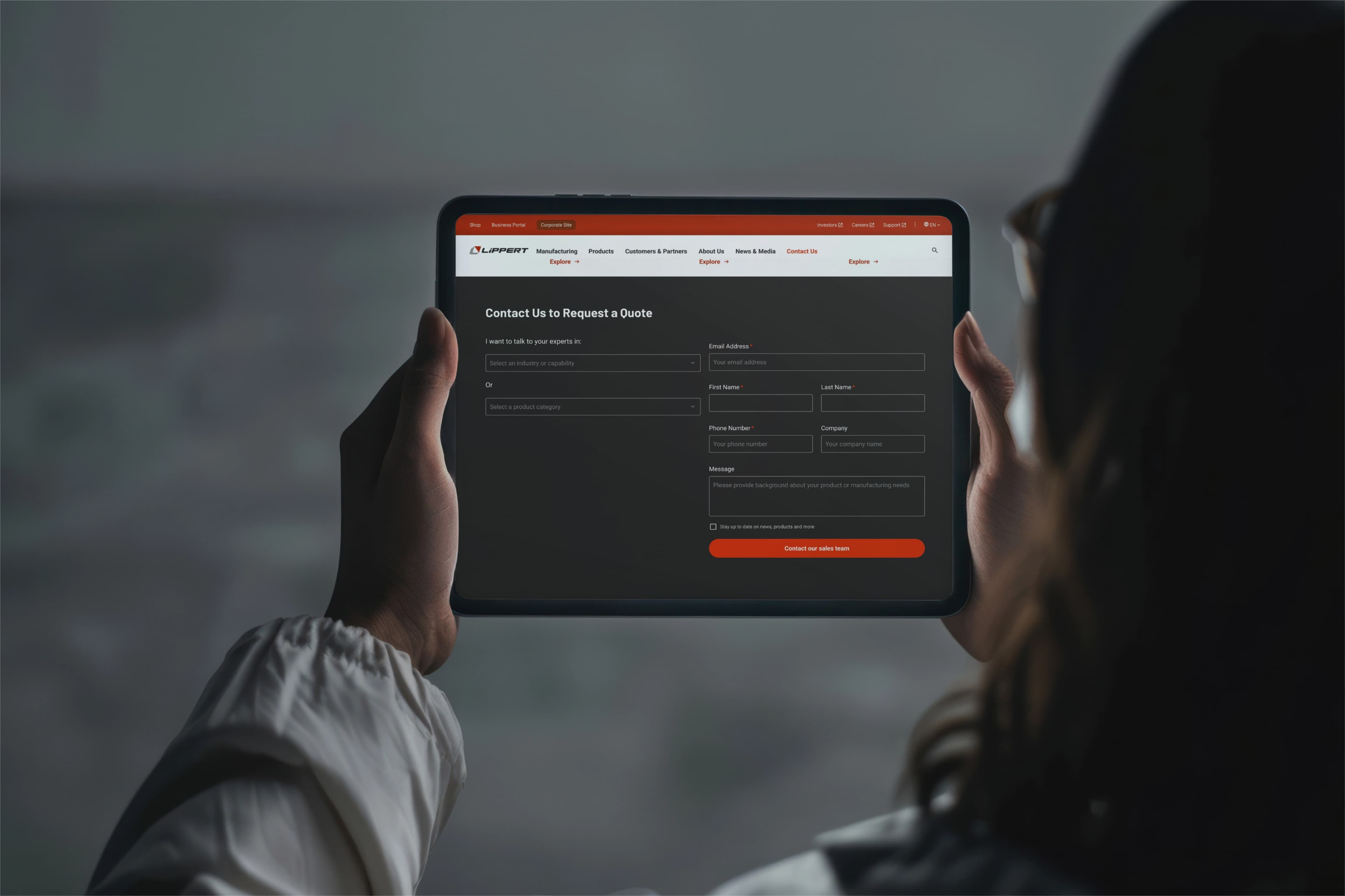 Hand holding tablet Lippert corporate