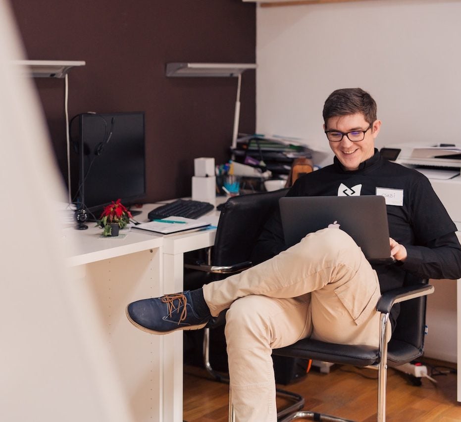 Image of happy Support Service team member on his laptop.