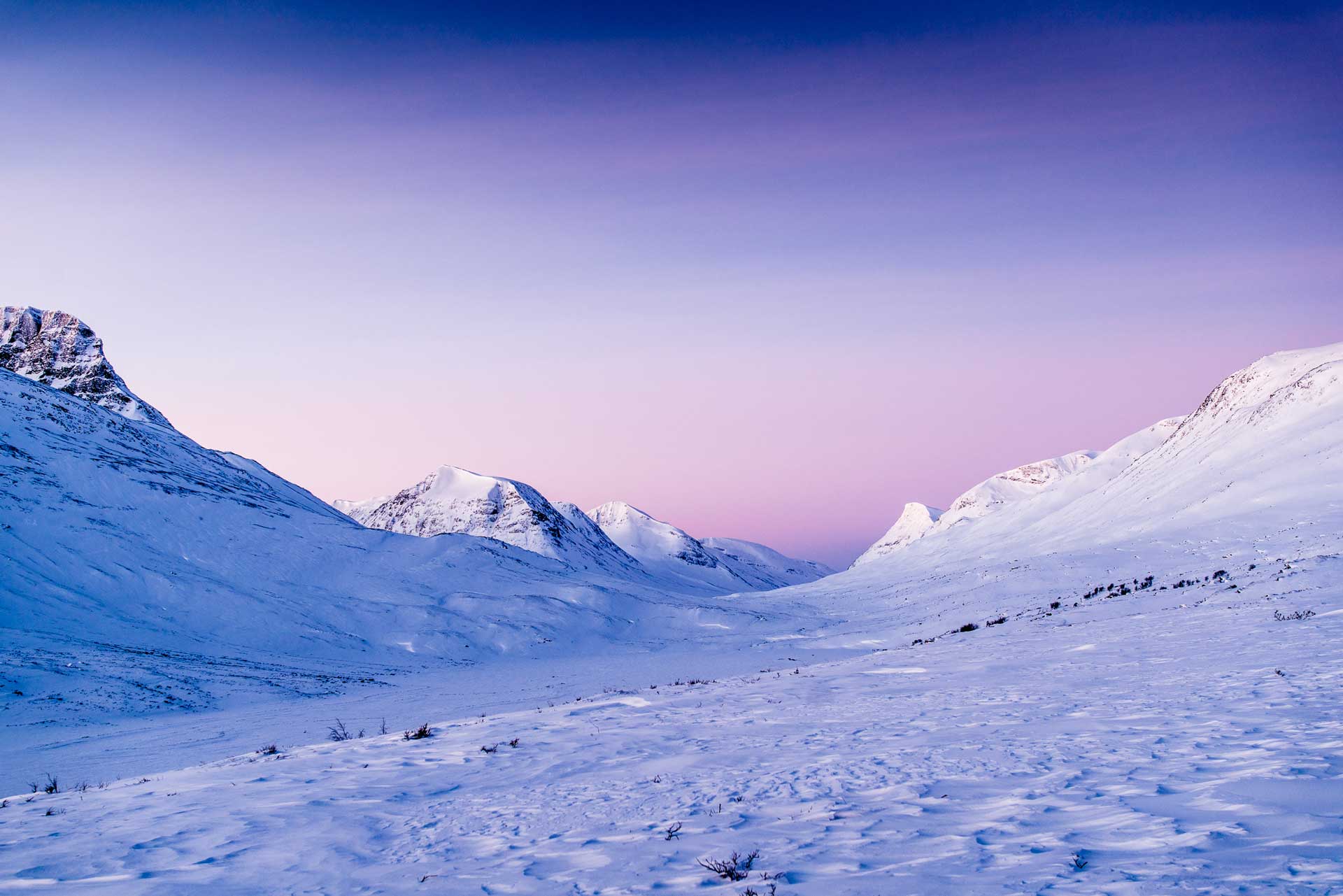 Purple and pink sky with snow covered mountains