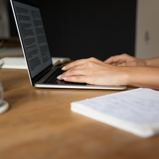 hands typing on laptop