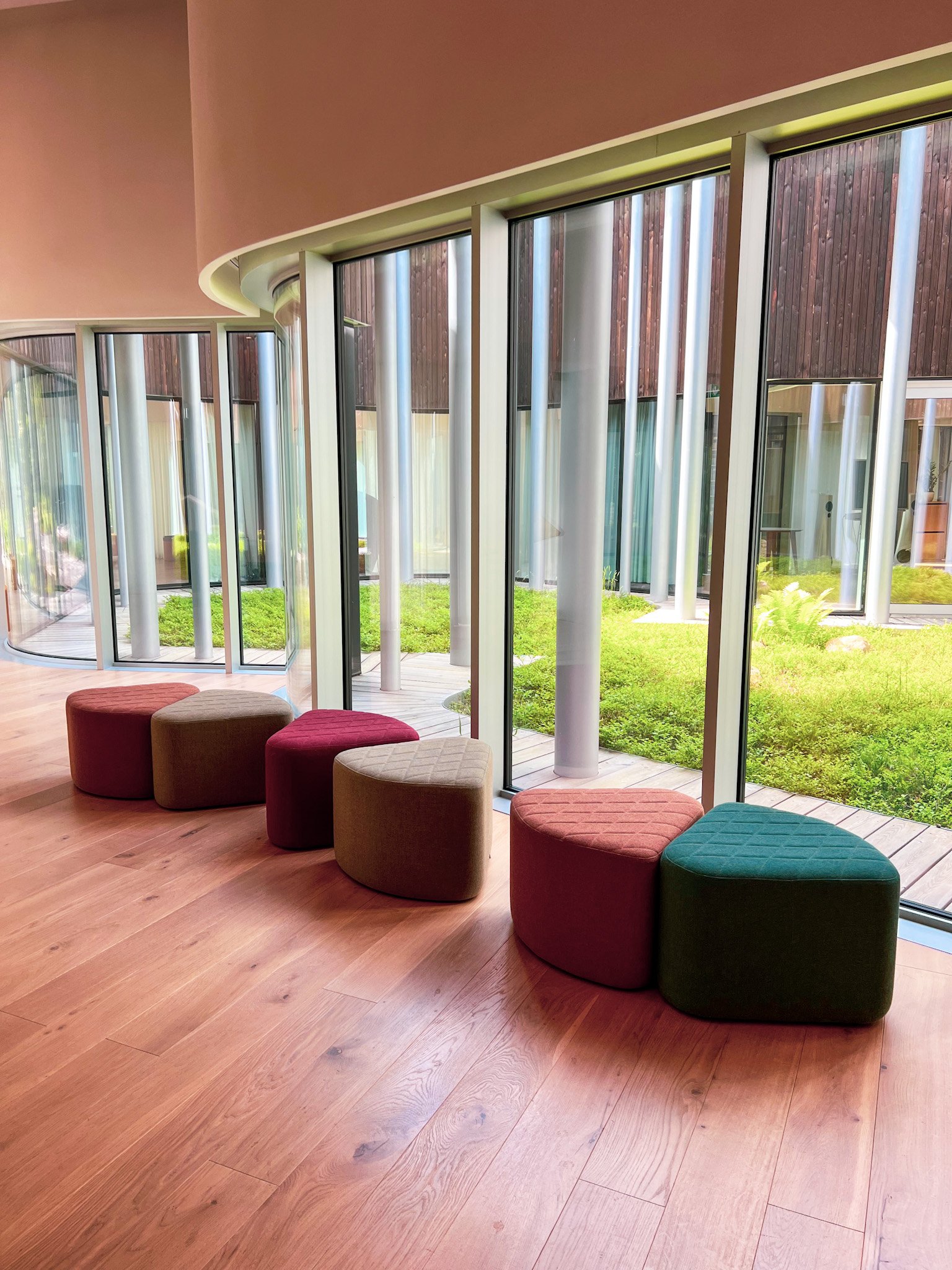 Image of a serene office space with poufs.