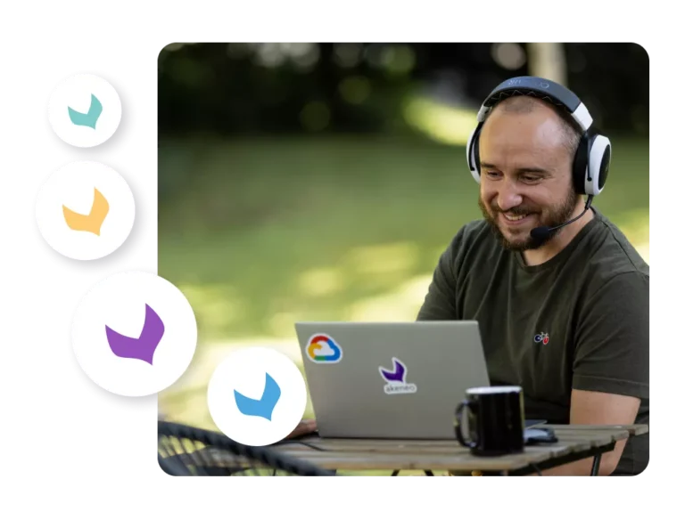 Image of happy man behind computer. Photo credit: Akeneo