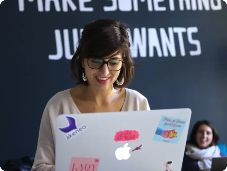 Image of woman behind laptop. Photo credit: Akeneo