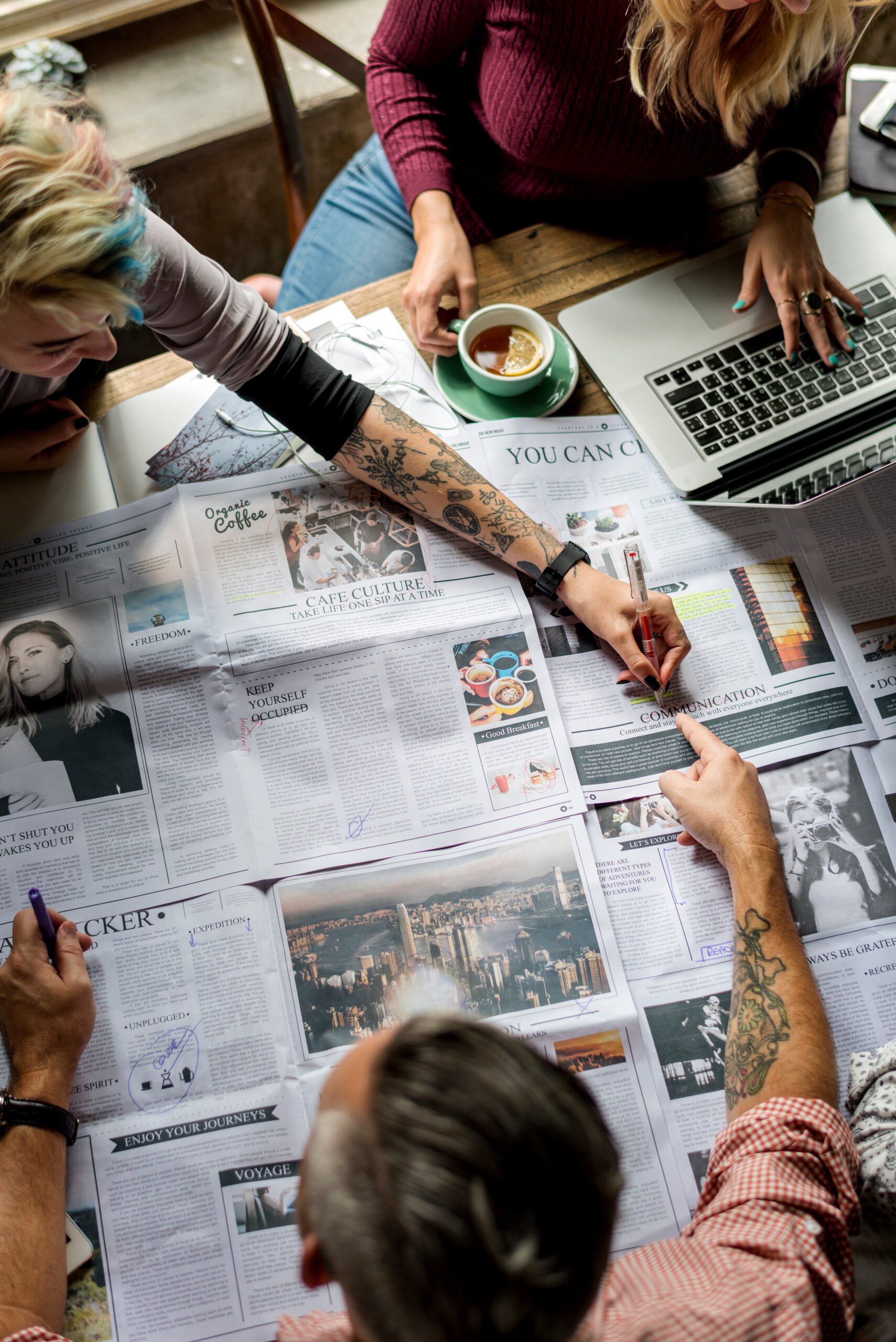 Overhead shot of three people working around a table.