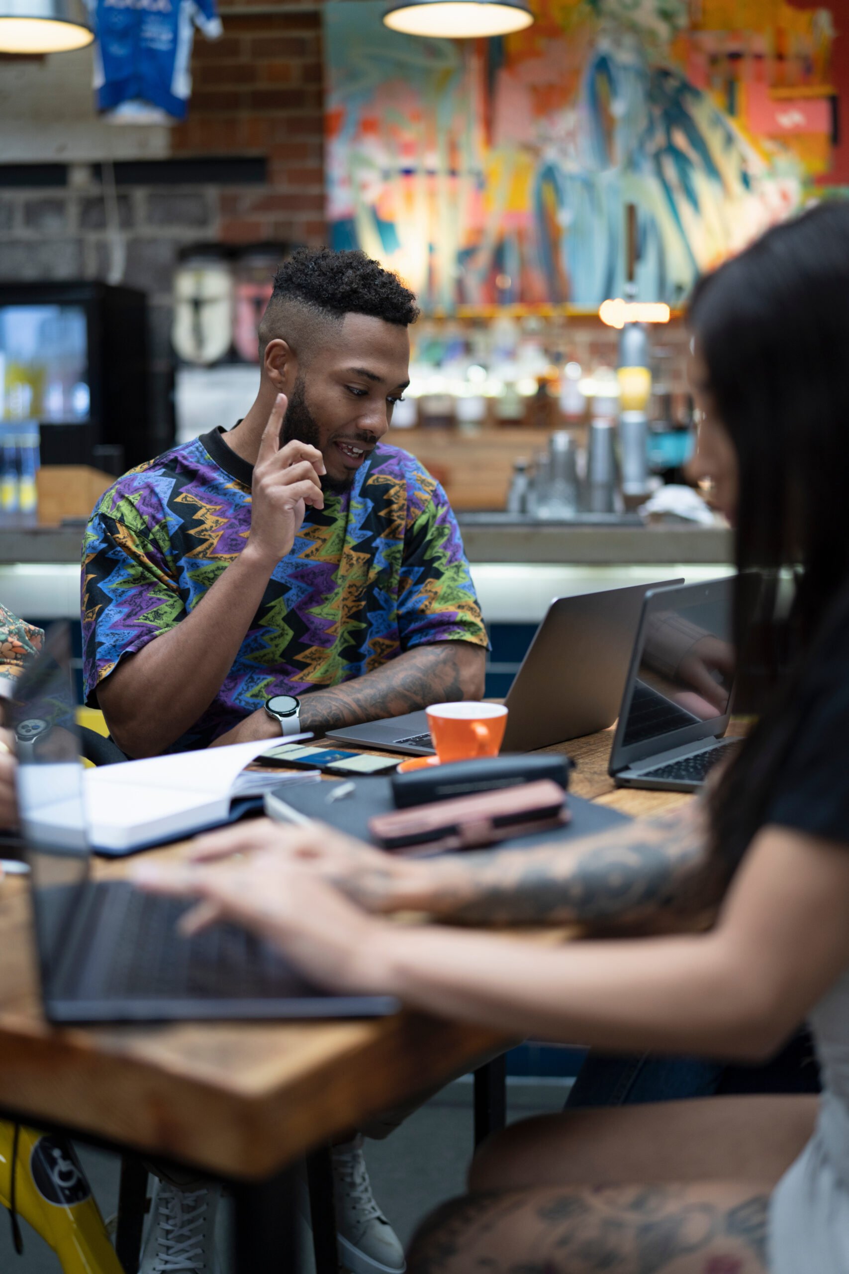 A man and woman working in a modern workplace.