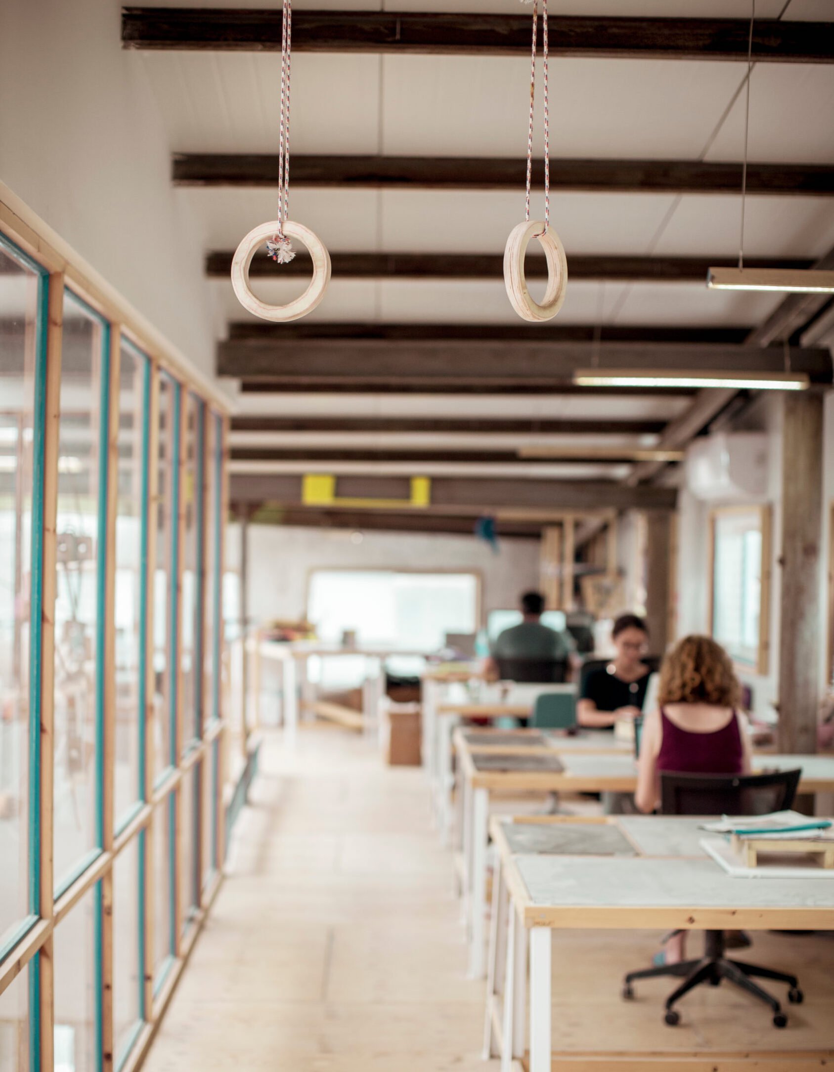 Creative office environment featuring a set of workout equipment (rings)