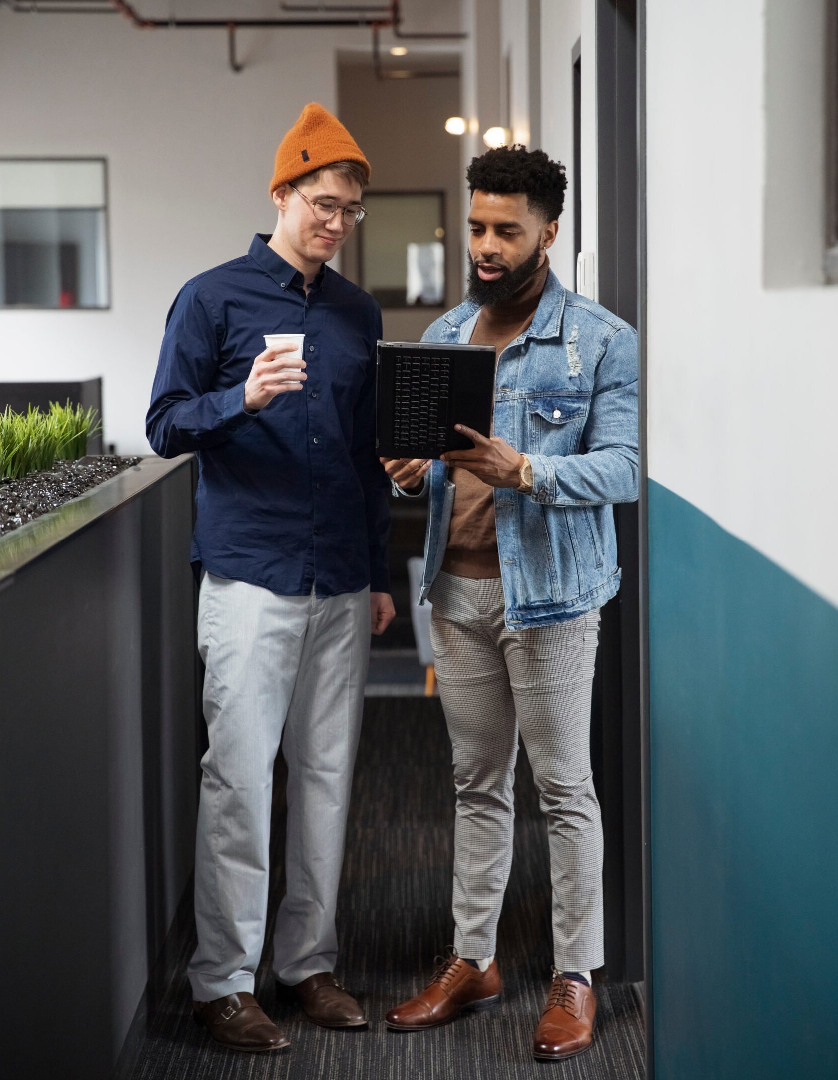 Two men talking together in an office setting