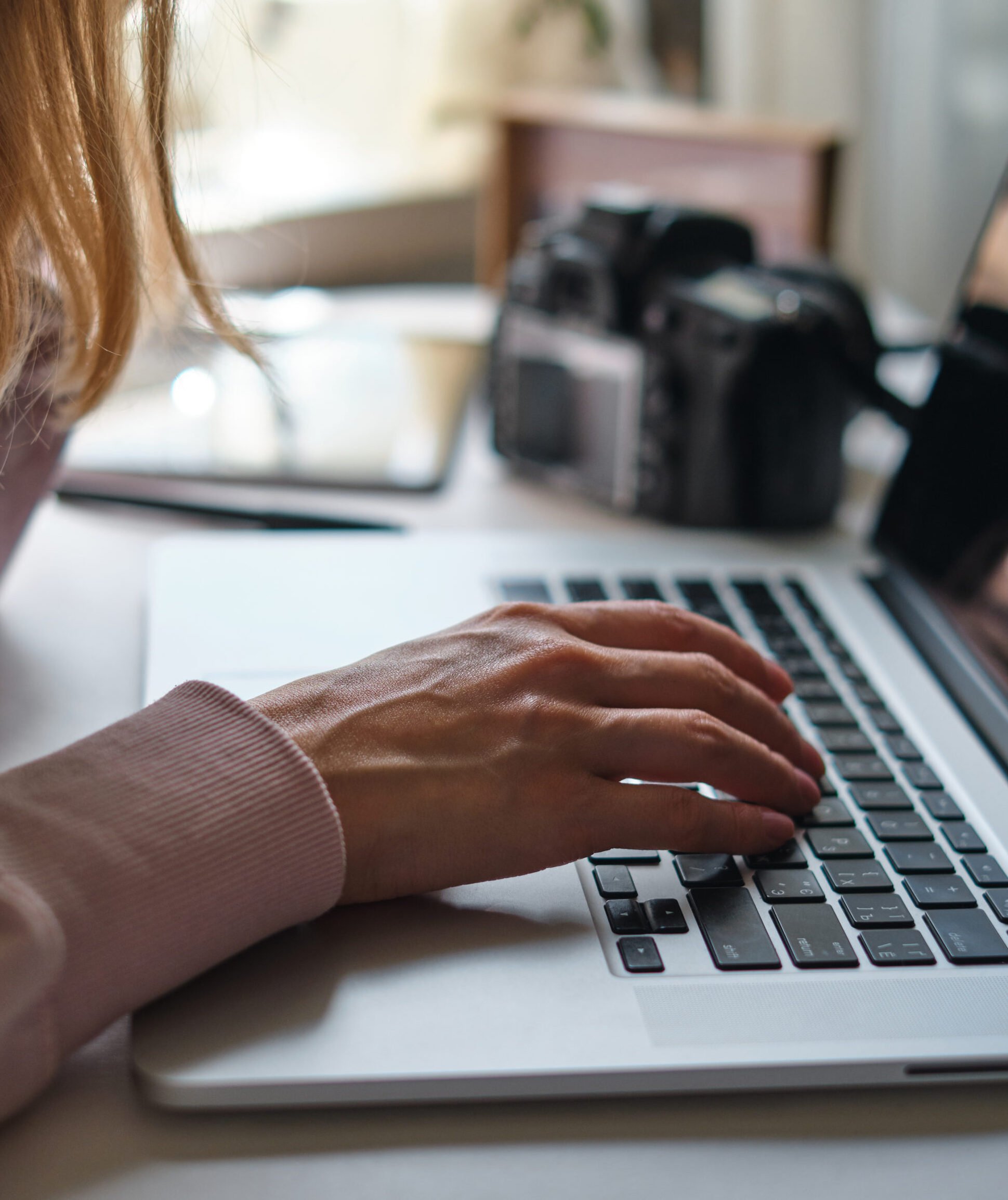 Close-up image of woman working behind a computer