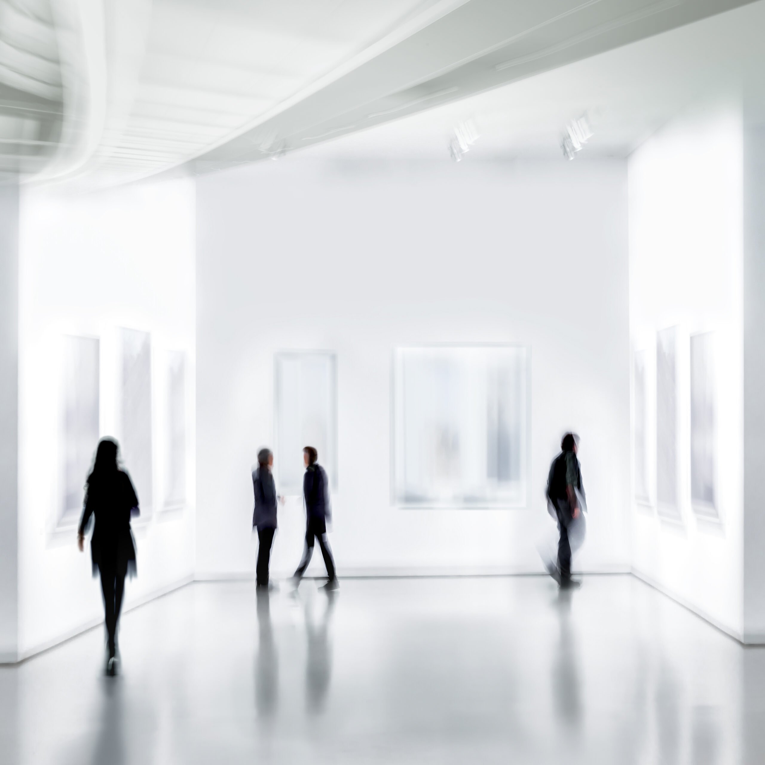 abstract image of people in the lobby of a modern art center with a blurred background