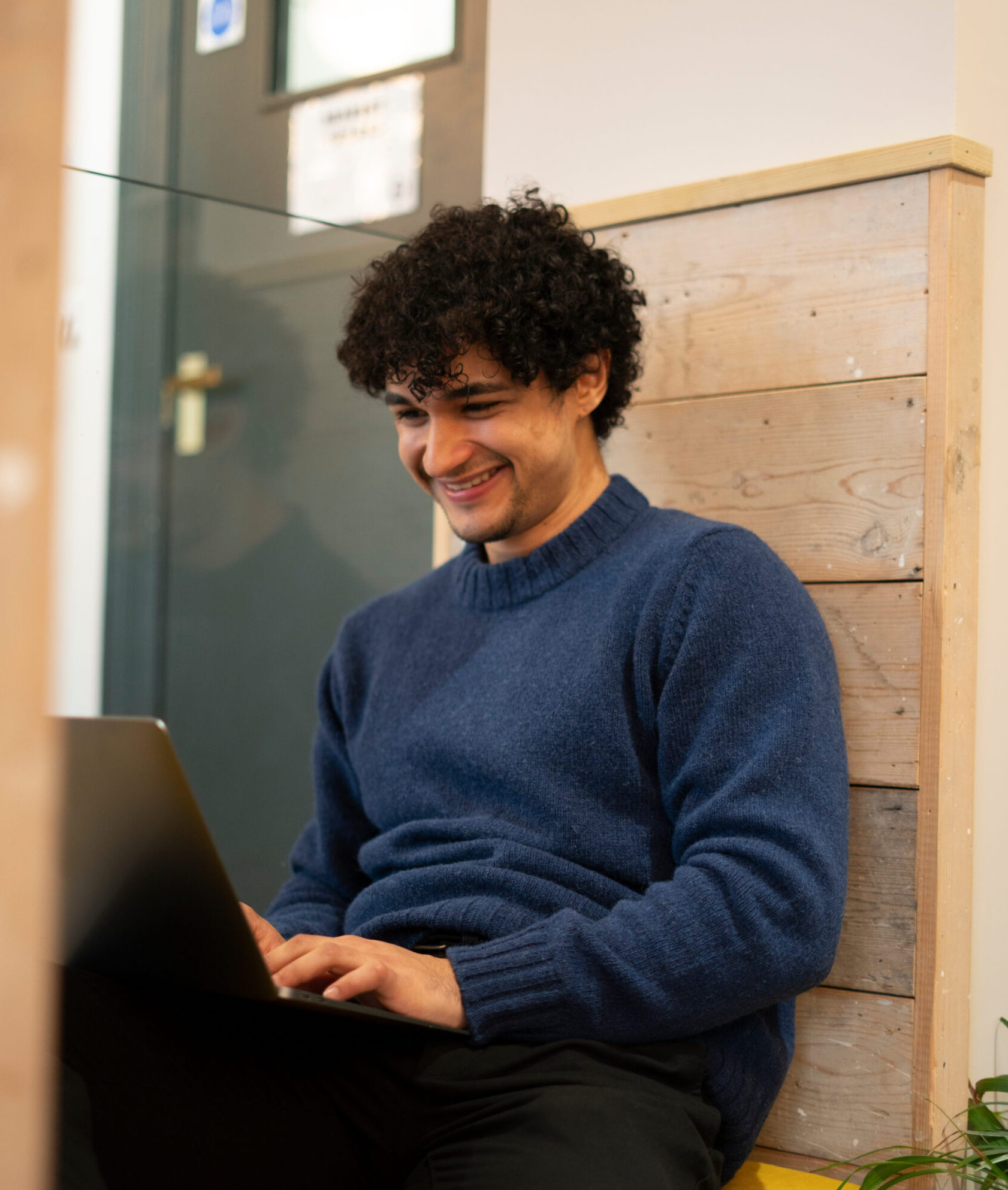 Happy man working behind a laptop