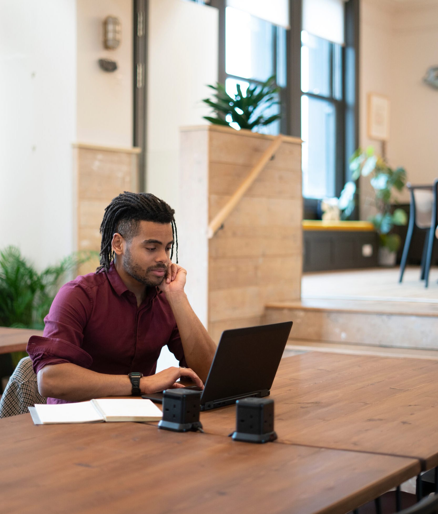 Man working behind laptop at a table in an office