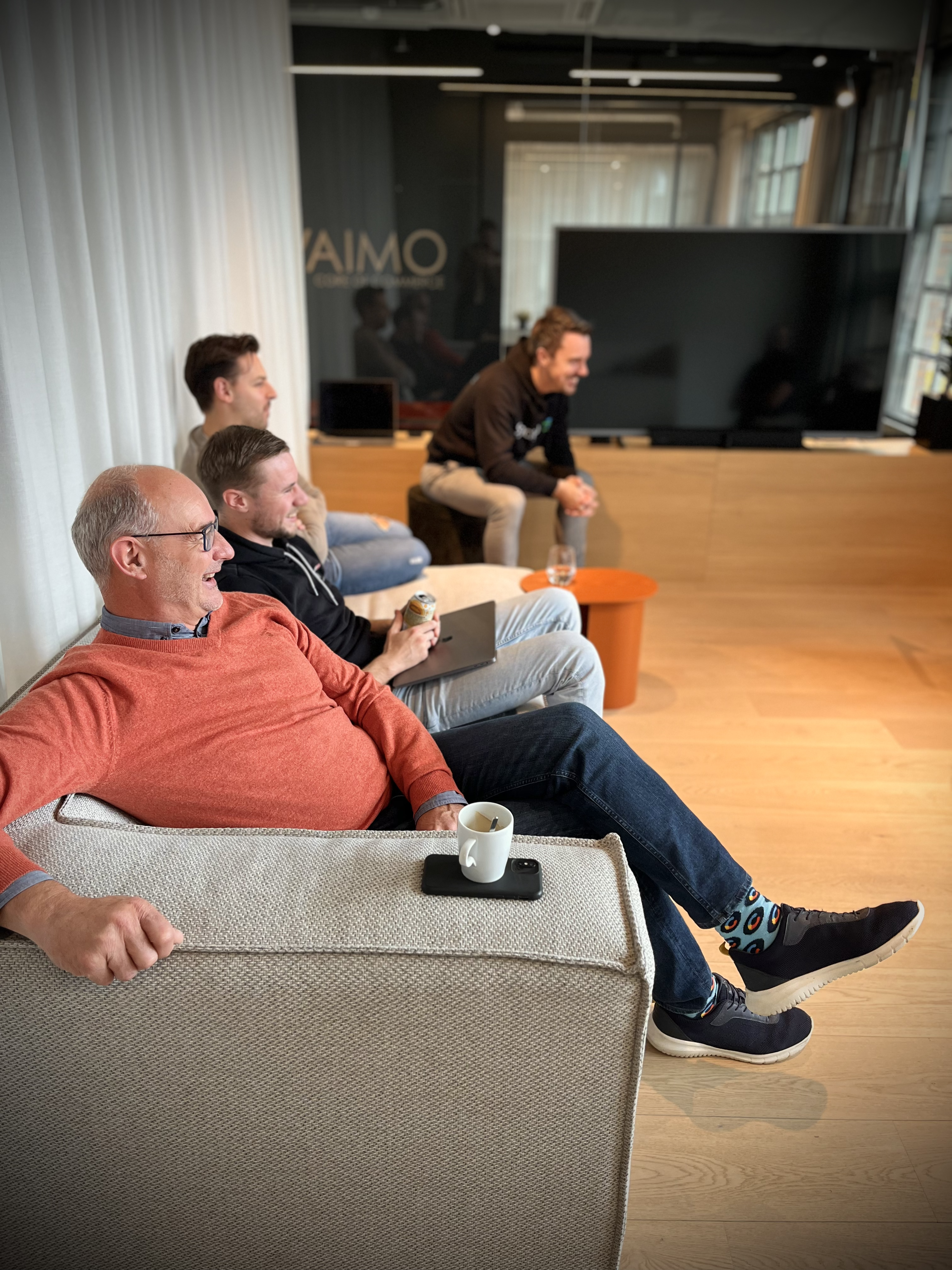 Happy Vaimo employees on the couch