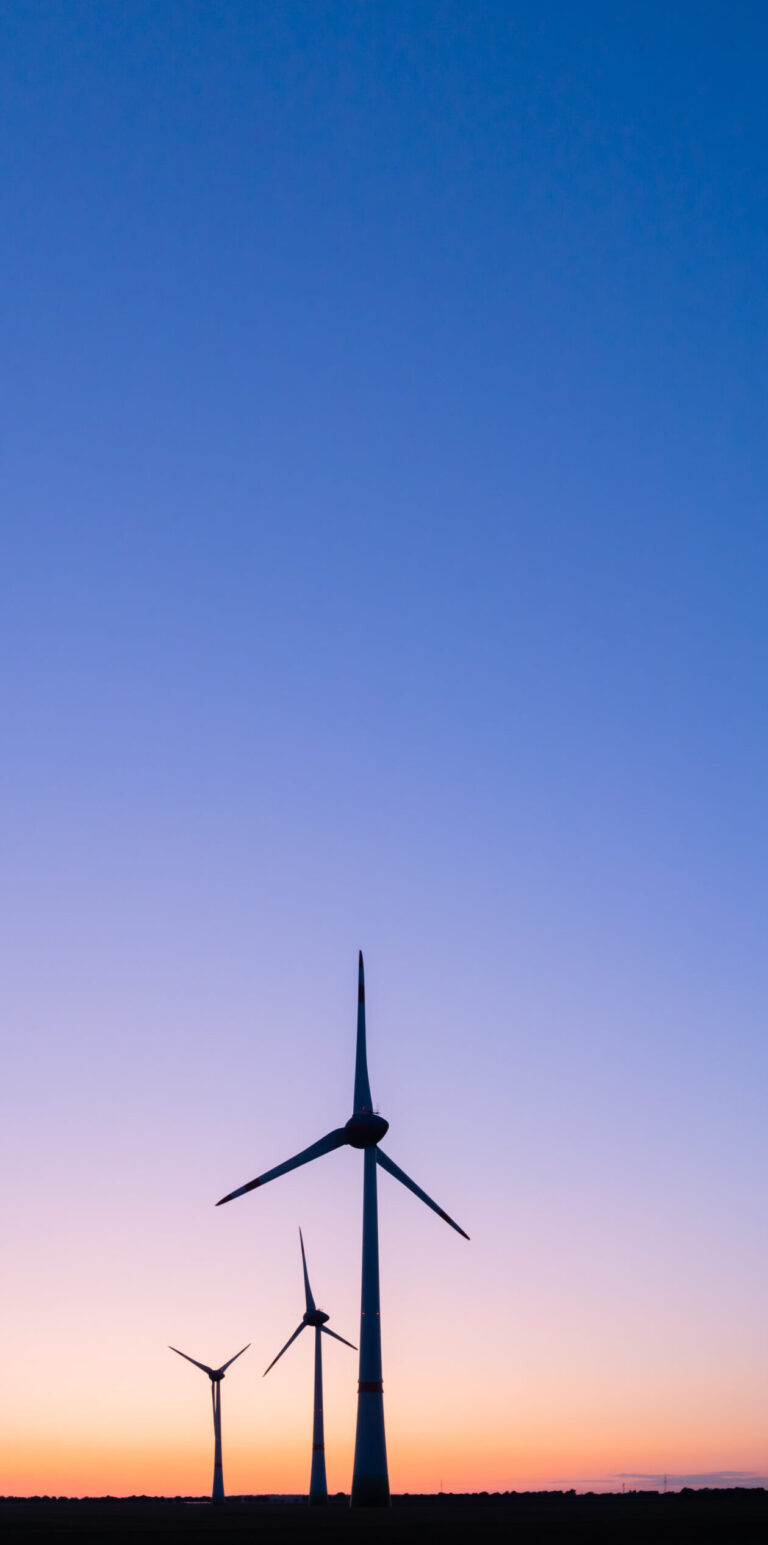 Image of a windmill against blue sky.
