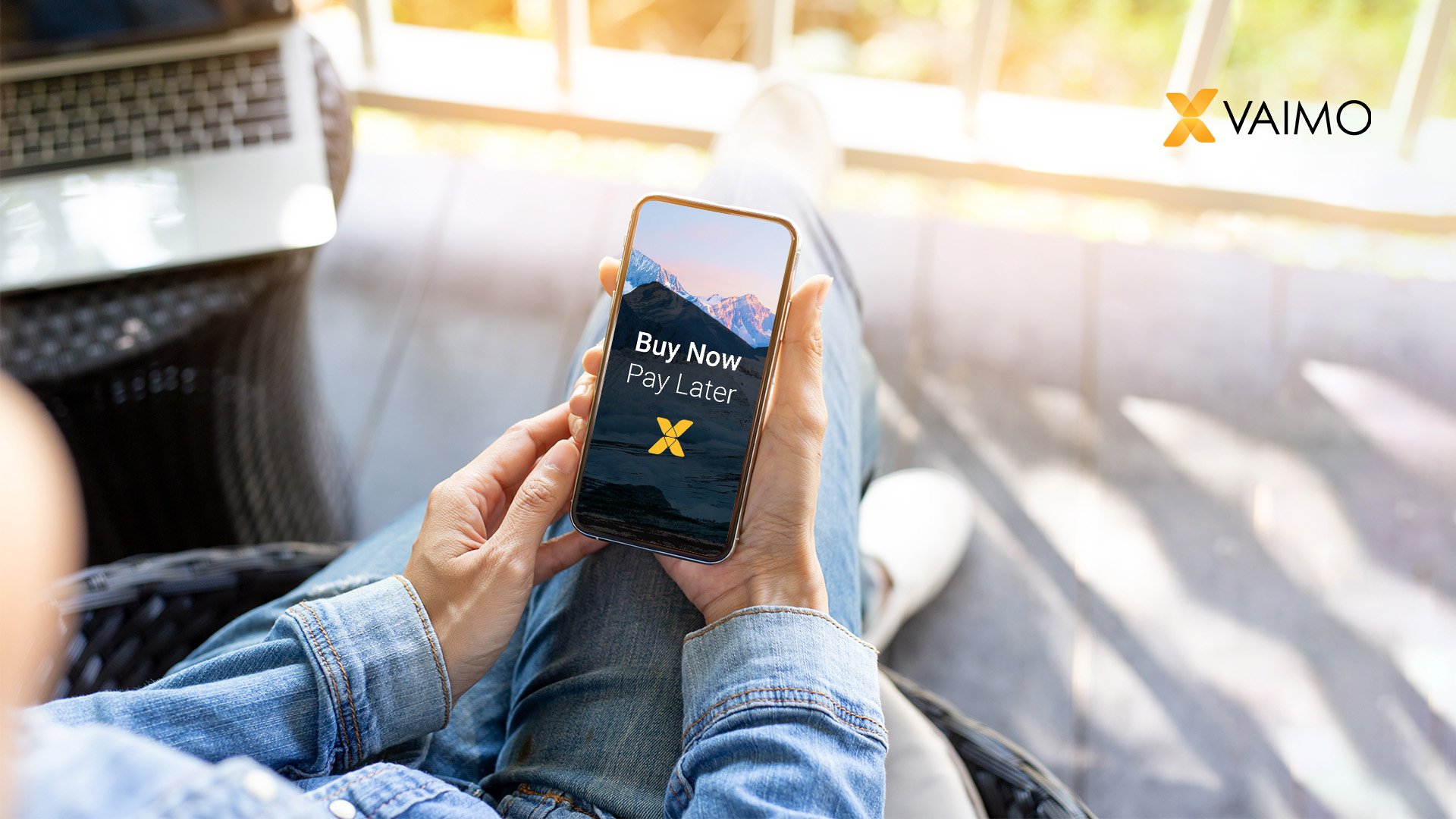 image of person holding mobile phone with buy now pay later written on the screen