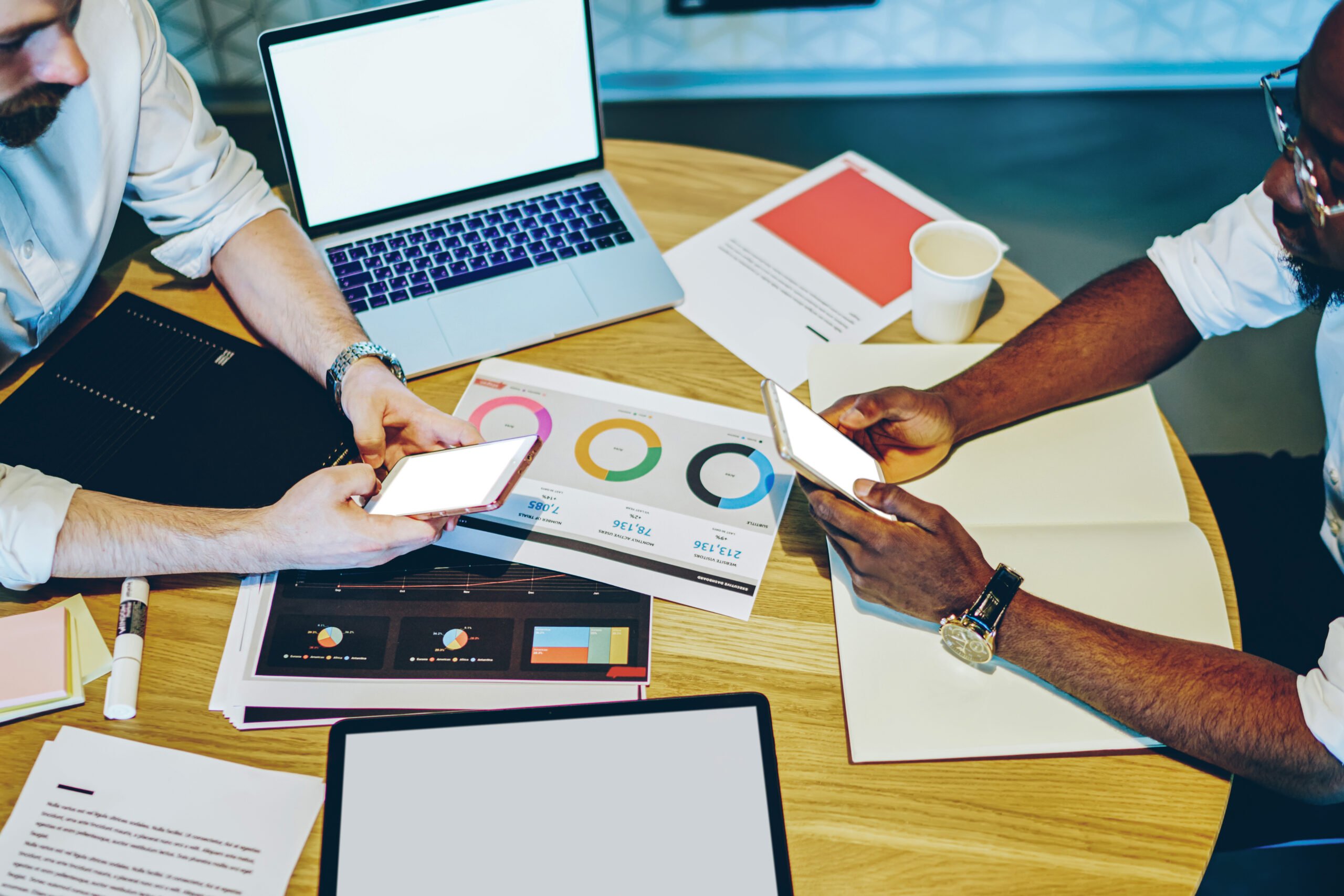 Image showing people working around a table with visuals spread out on papers