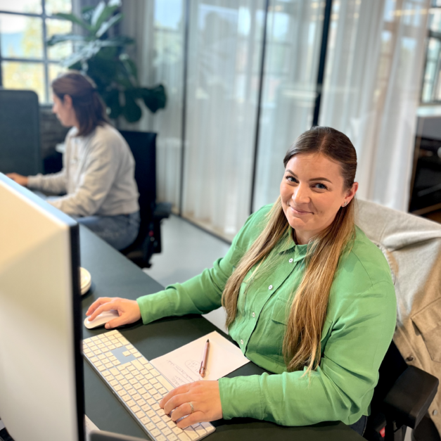 photo of smiling vaimo employee behind her computer