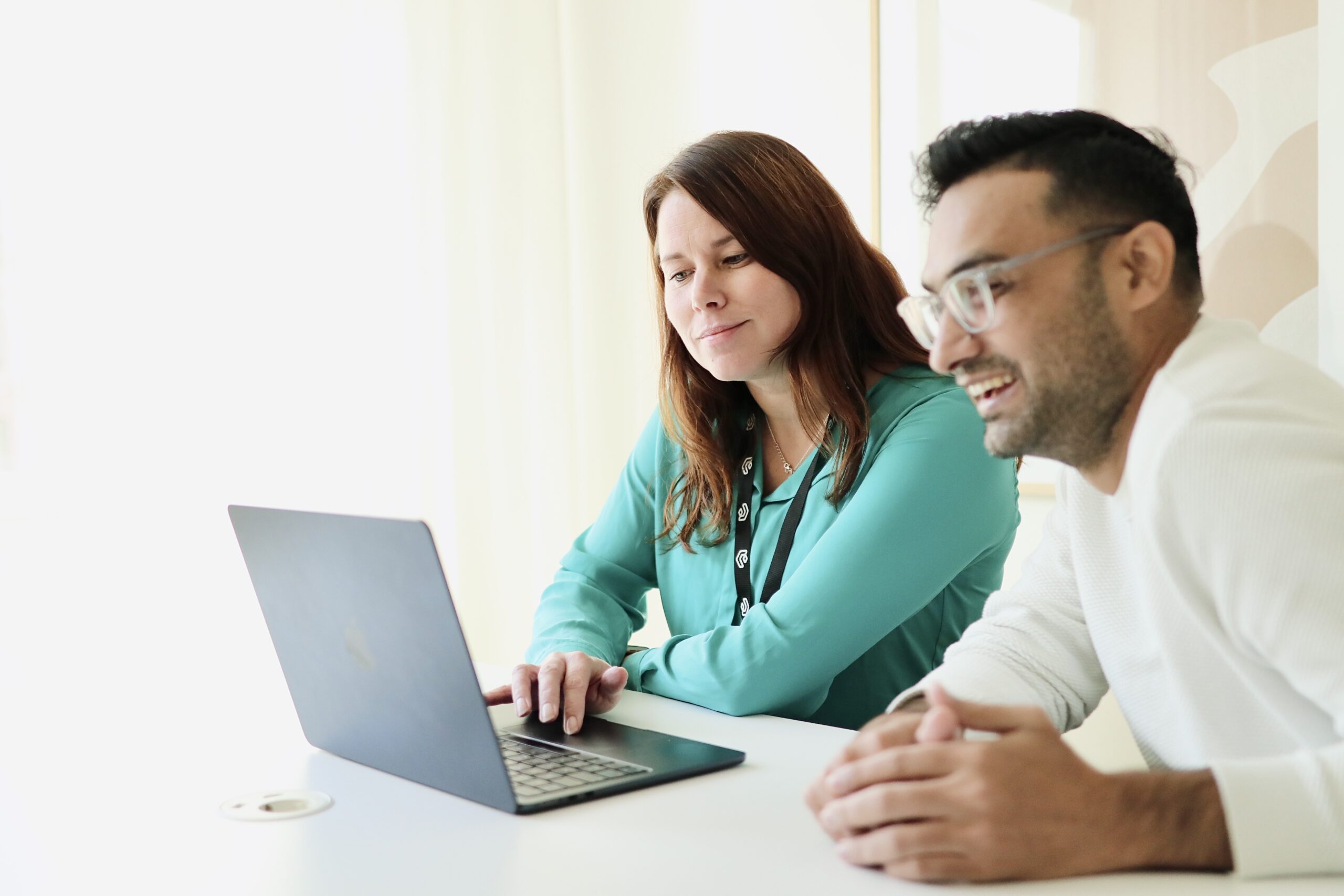 Two Vaimo employee sitting by laptop together